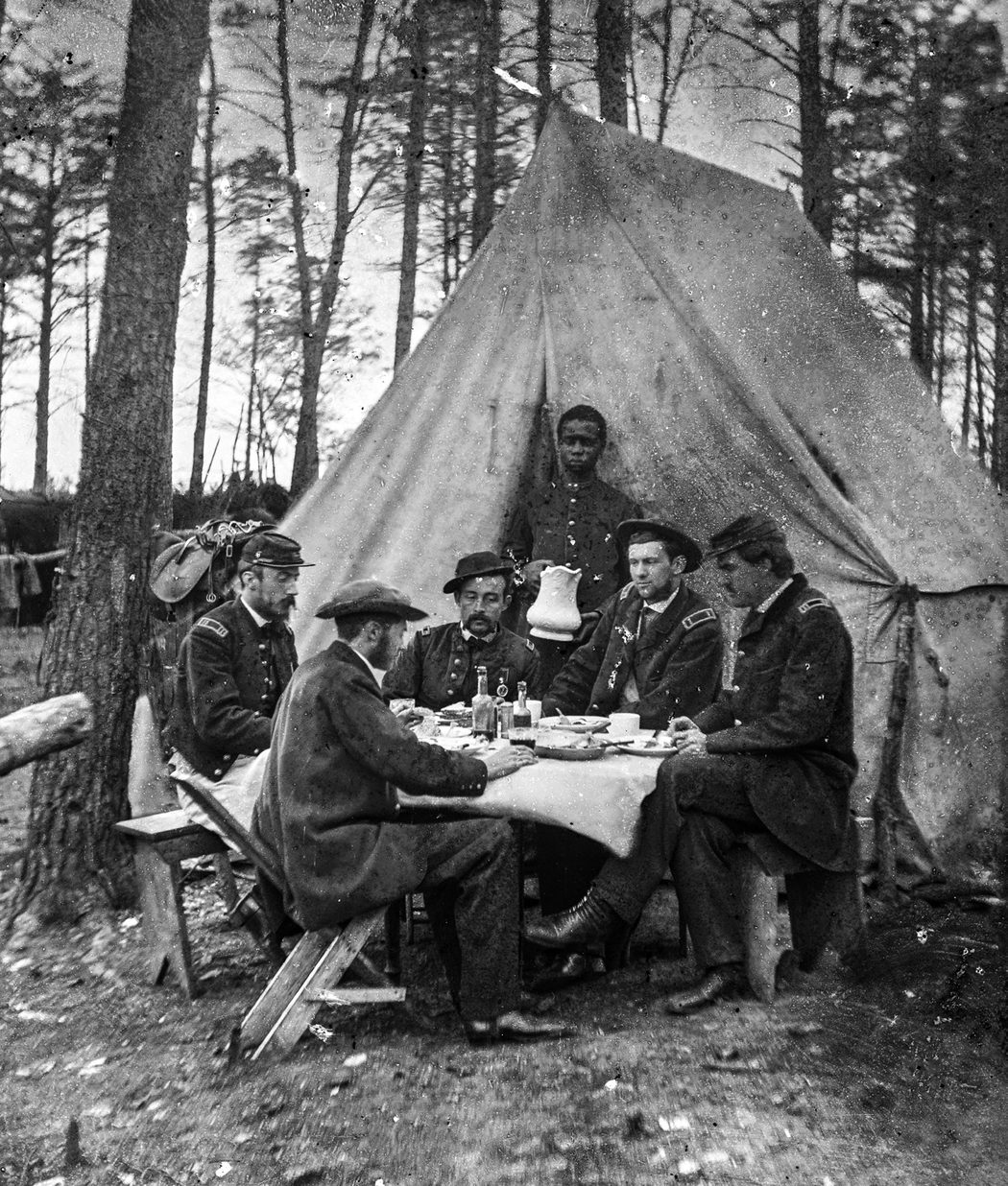 Brandy Station, Va. Dinner party outside tent, Army of the Potomac headquarters. Perhaps they are drinking tea with their meal? (Library of Congress)