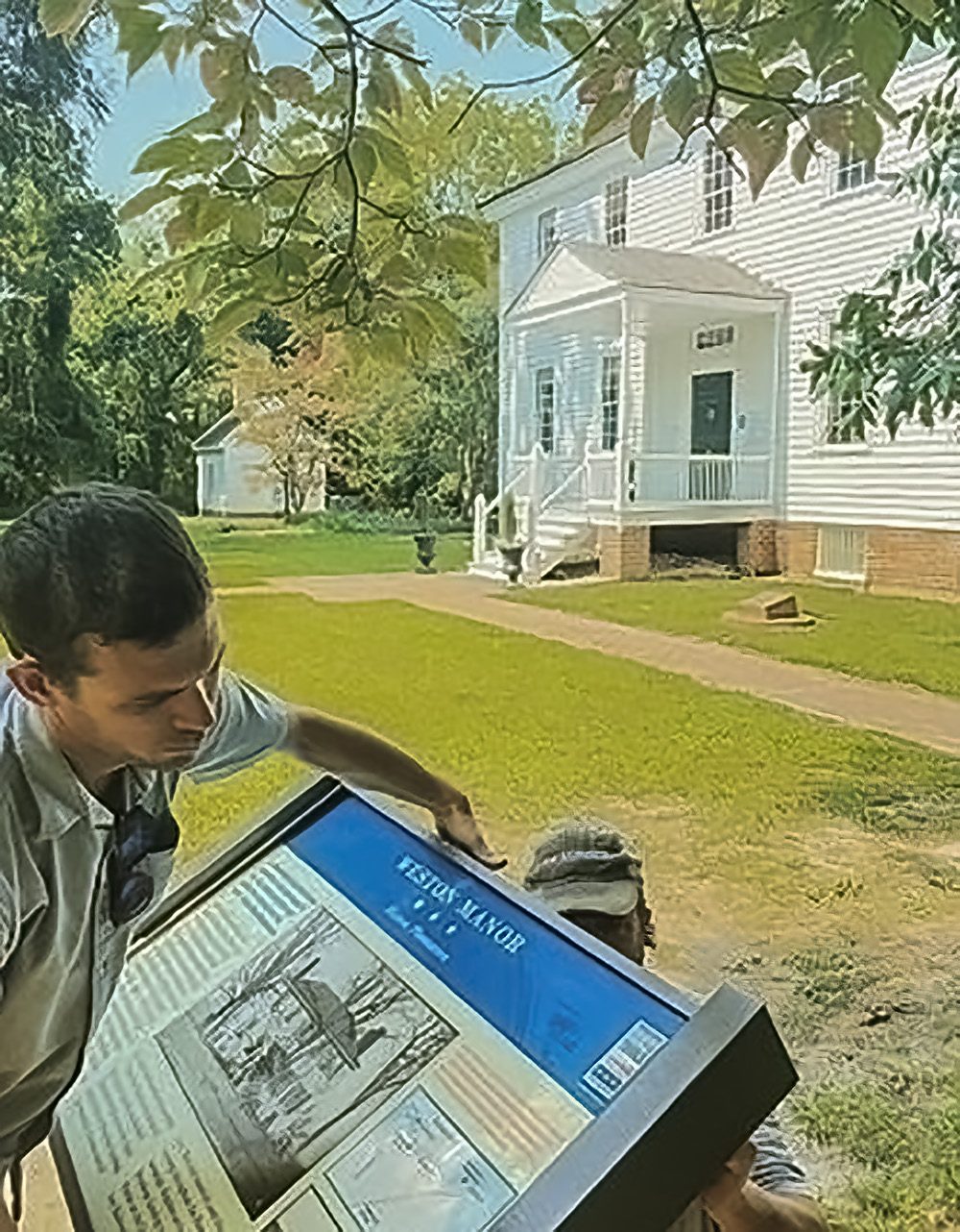 Chris Brown (left), Assistant Director, and Jason Shaffer (right), Operations Manager of Civil War Trails work to clean up and repair the sign pedestal before installing the new panel. Courtesy, Civil War Trails, Inc.